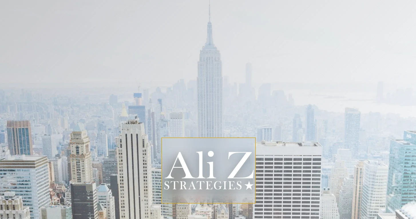 The Ali Z Strategies homepage: the firm's wordmark in a thin gold frame, centered over a pale aerial photograph of the Manhattan skyline
